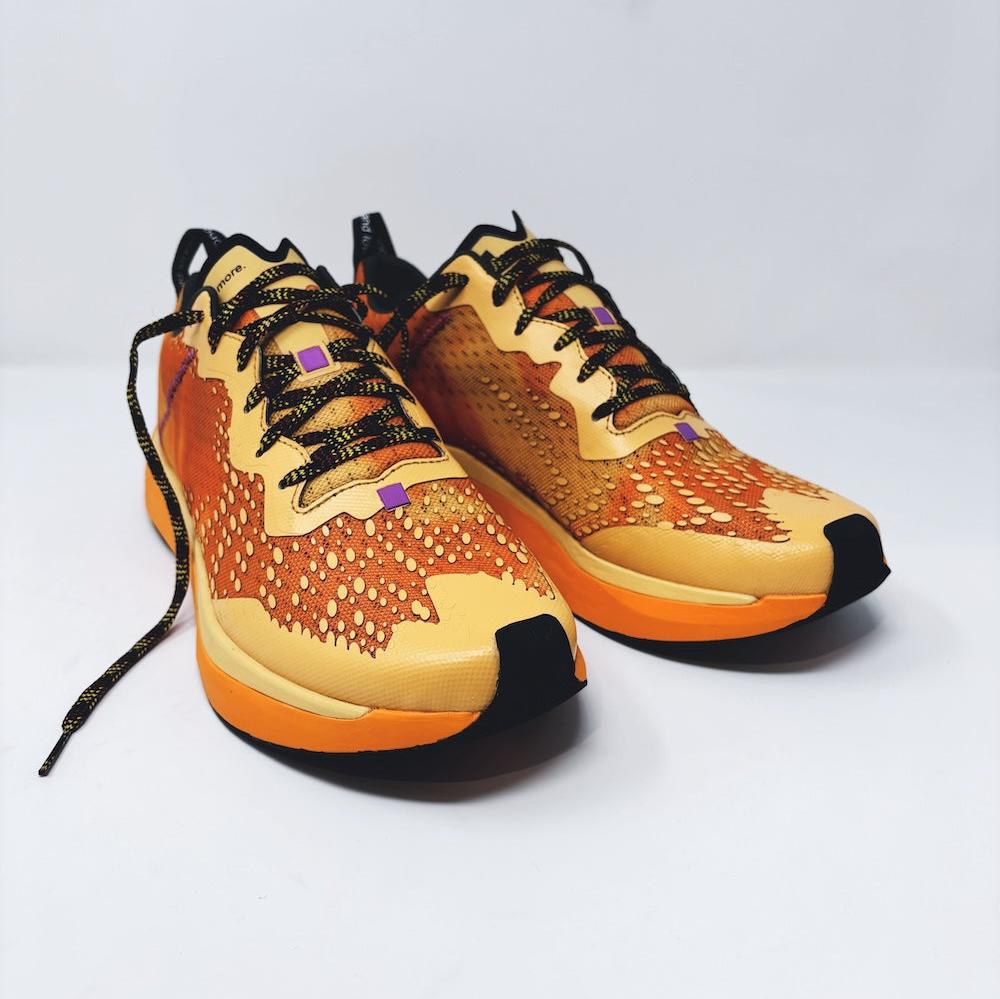 4T2 one more running shoe in orange, featuring a breathable upper and a durable rubber outsole designed for speed and traction.