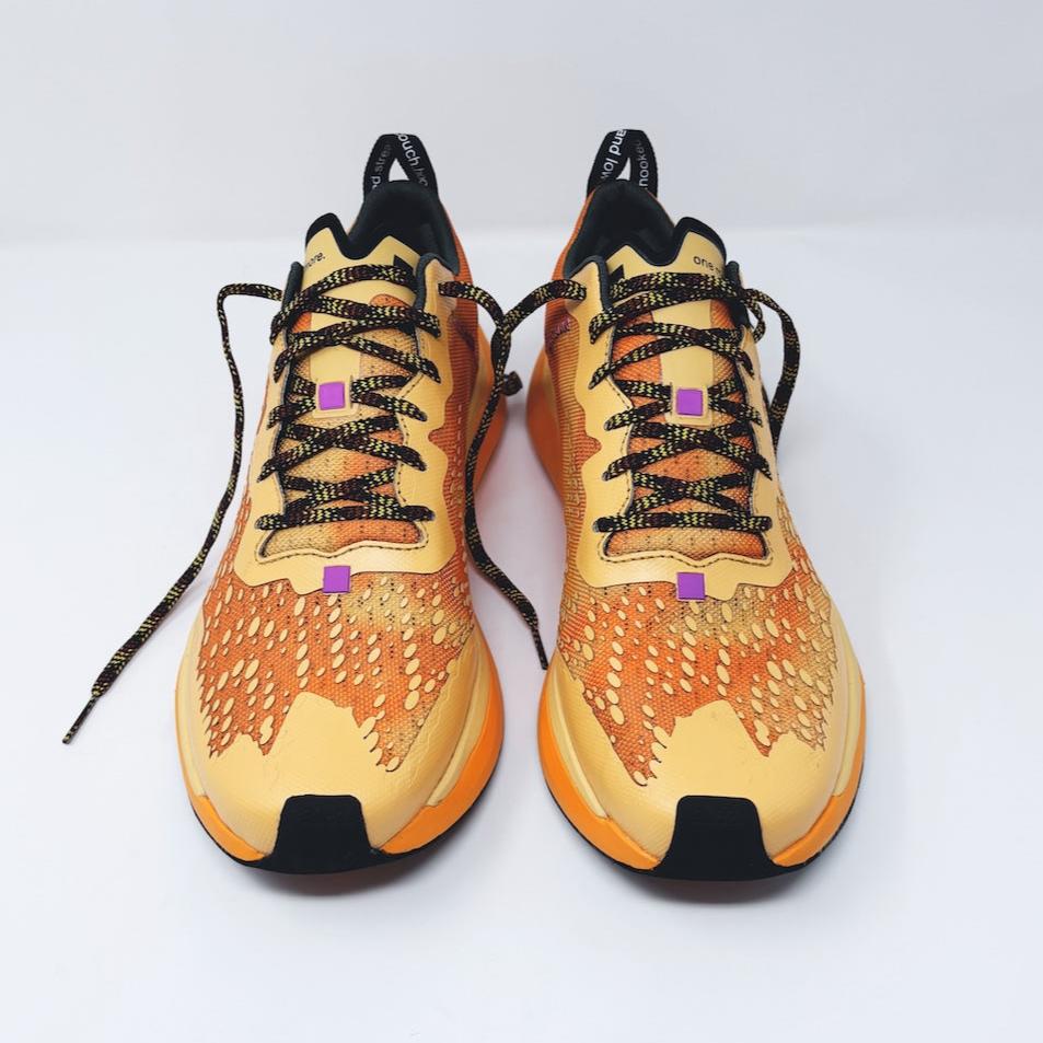 4T2 one more running shoe in orange, featuring a breathable upper and a durable rubber outsole designed for speed and traction.