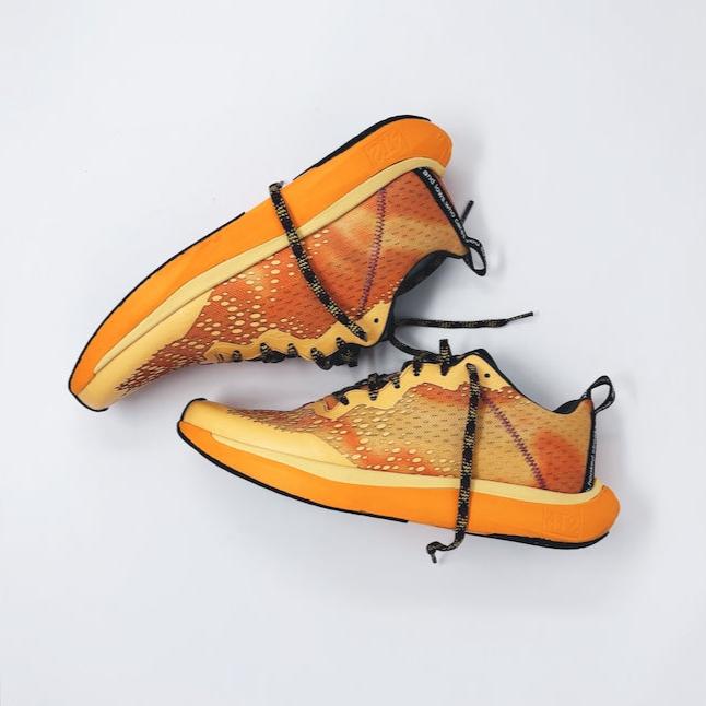 4T2 one more running shoe in orange, featuring a breathable upper and a durable rubber outsole designed for speed and traction.