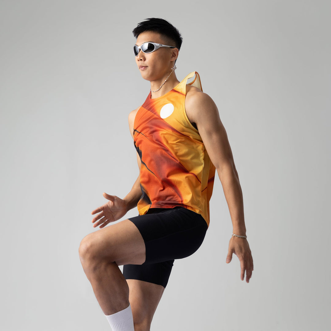 A lightweight and breathable orange singlet from Participation, designed for activewear with moisture-wicking properties.
