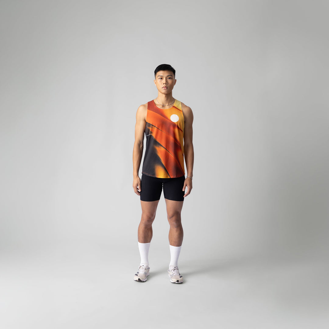 A lightweight and breathable orange singlet from Participation, designed for activewear with moisture-wicking properties.