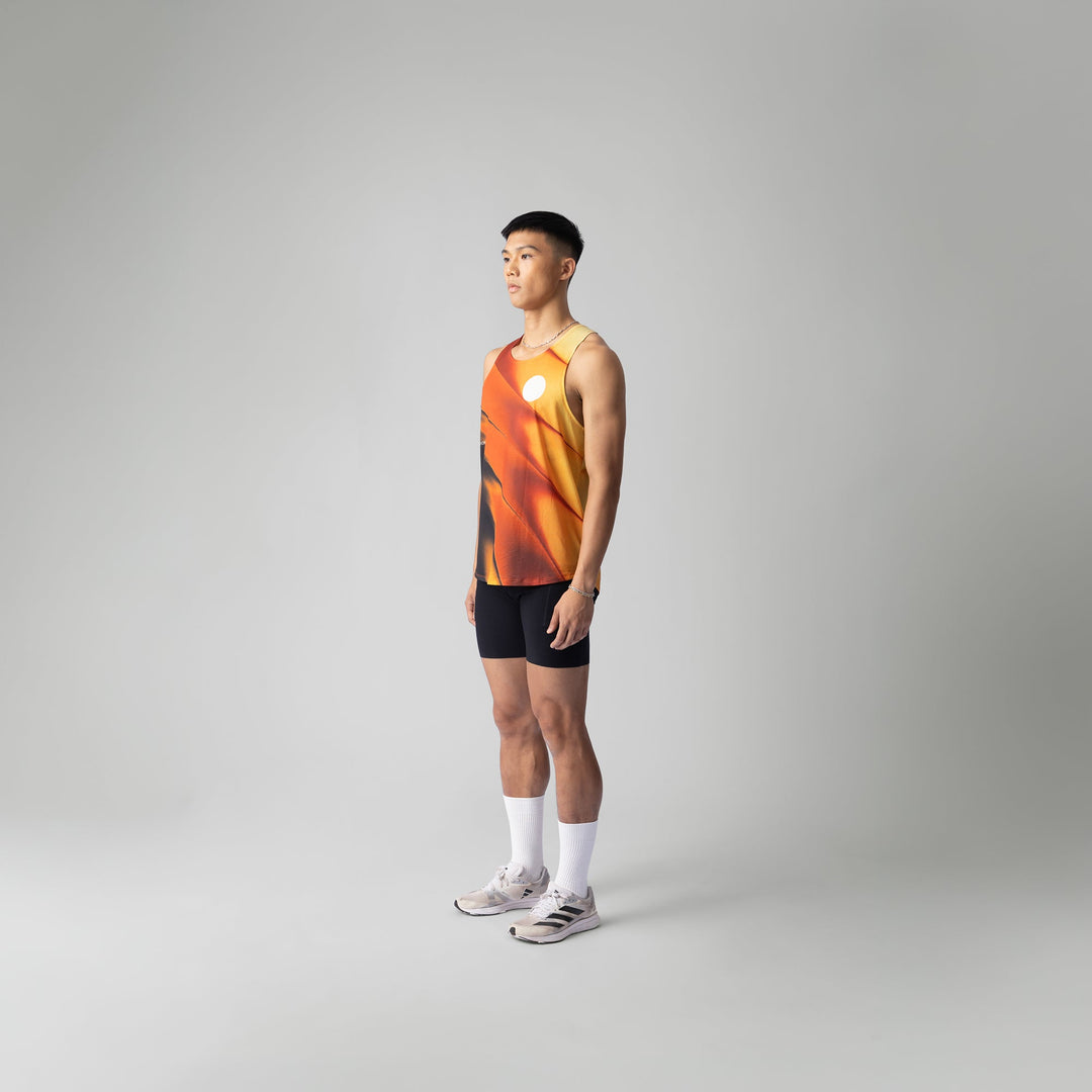 A lightweight and breathable orange singlet from Participation, designed for activewear with moisture-wicking properties.