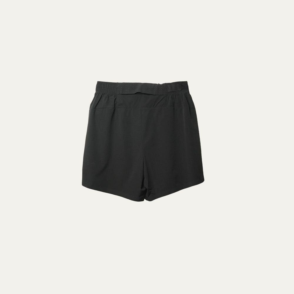 Plain black running shorts from Participation, minimalist design with balanced storage and integrated liner, photographed in a neutral studio setting.
