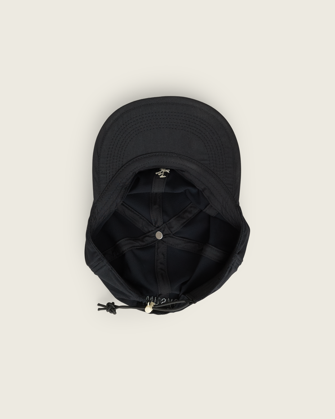 6-panel mesh running cap in Buttercup and Black from Sysum, lightweight construction with soft foam bill and adjustable back strap visible, photographed in a neutral studio setting.