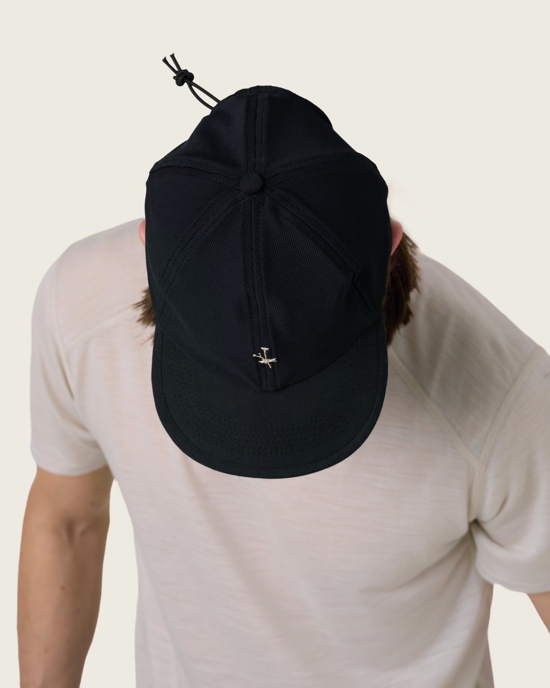 6-panel mesh running cap in Buttercup and Black from Sysum, lightweight construction with soft foam bill and adjustable back strap visible, photographed in a neutral studio setting.