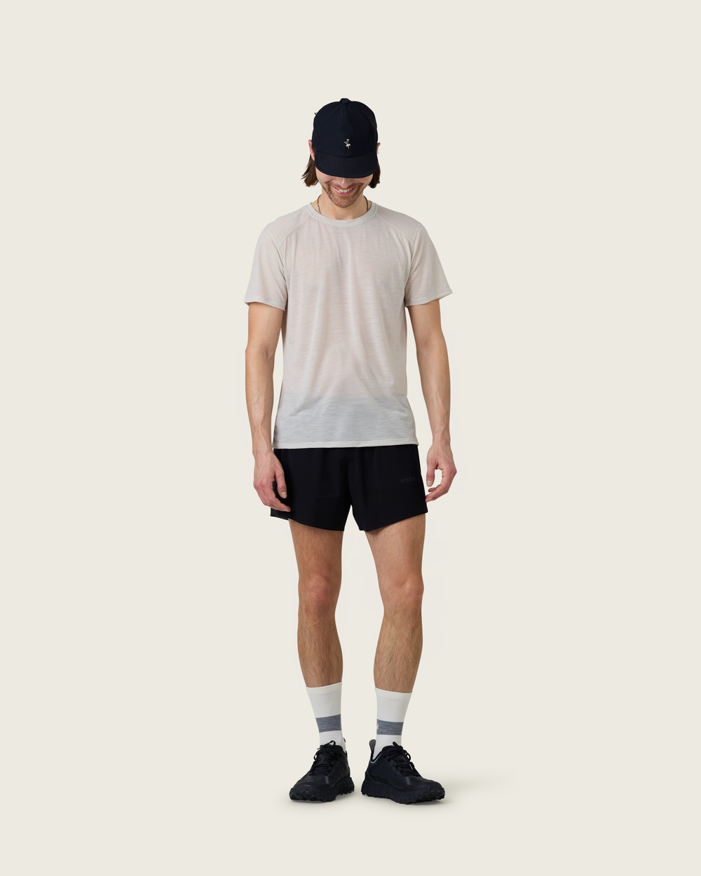 Men’s ultra-light merino short-sleeve running tee in Pebble from Sysum, fine knit texture visible, photographed in a neutral studio setting.