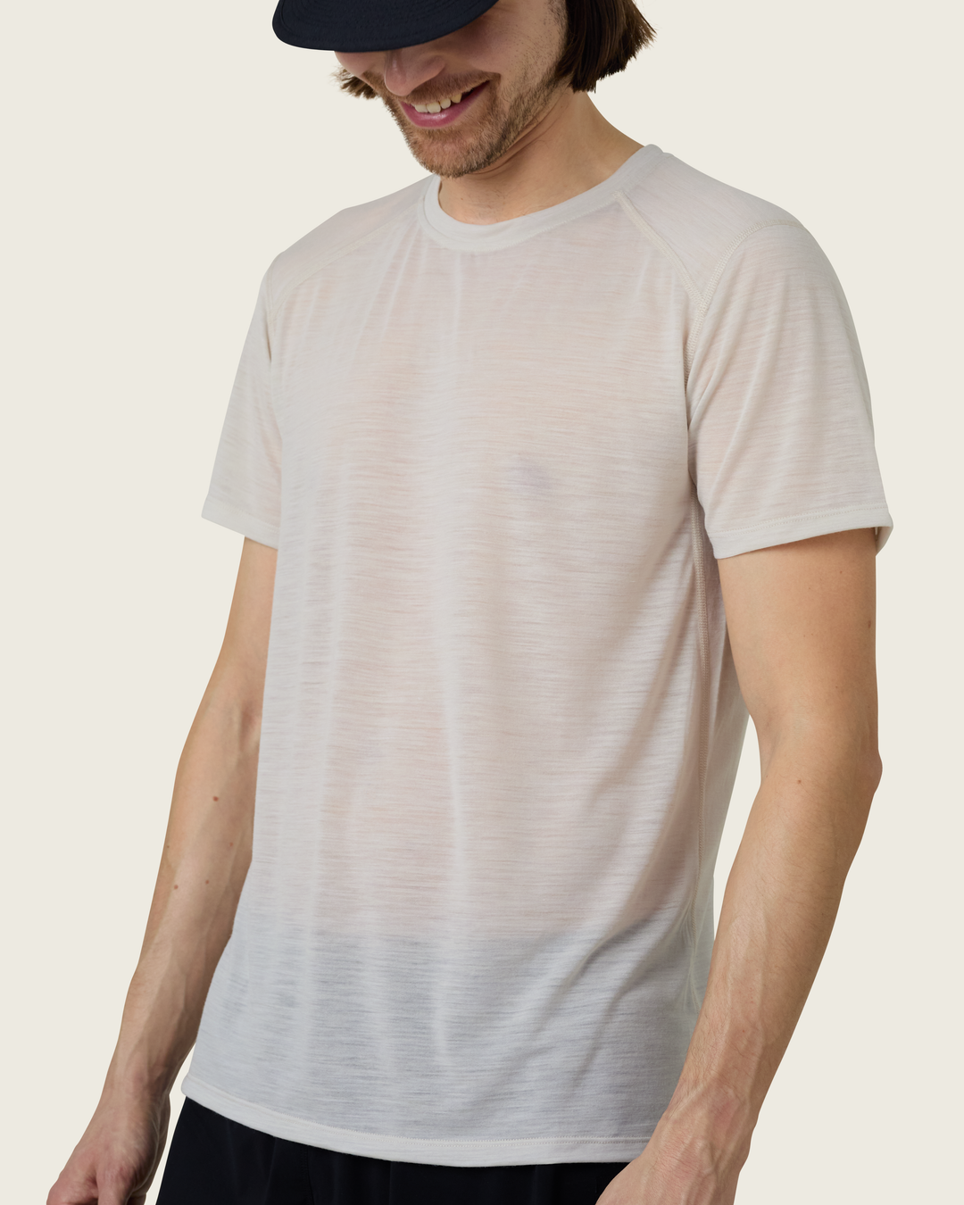 Men’s ultra-light merino short-sleeve running tee in Pebble from Sysum, fine knit texture visible, photographed in a neutral studio setting.