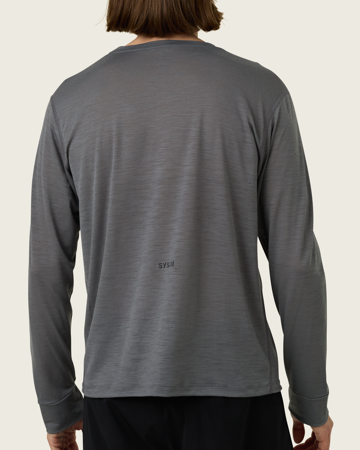 Men’s merino long-sleeve running top in Slate from Sysum, lightweight knit visible, photographed in a neutral studio setting.
