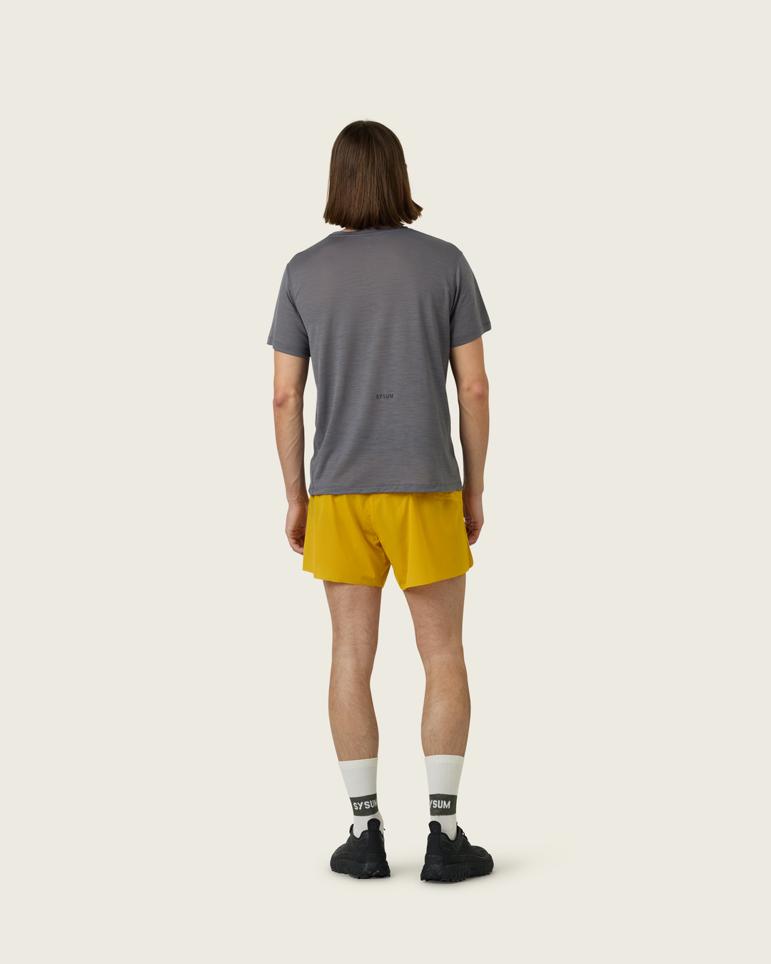 Men’s merino short-sleeve running tee in Slate from Sysum, lightweight knit texture visible, photographed in a neutral studio setting.