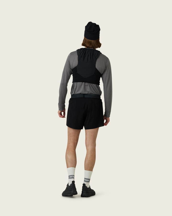 Men’s 4-inch Cordura® trail running shorts in Black from Sysum, ultra-light stretch fabric and pocket system visible, photographed in a neutral studio setting.