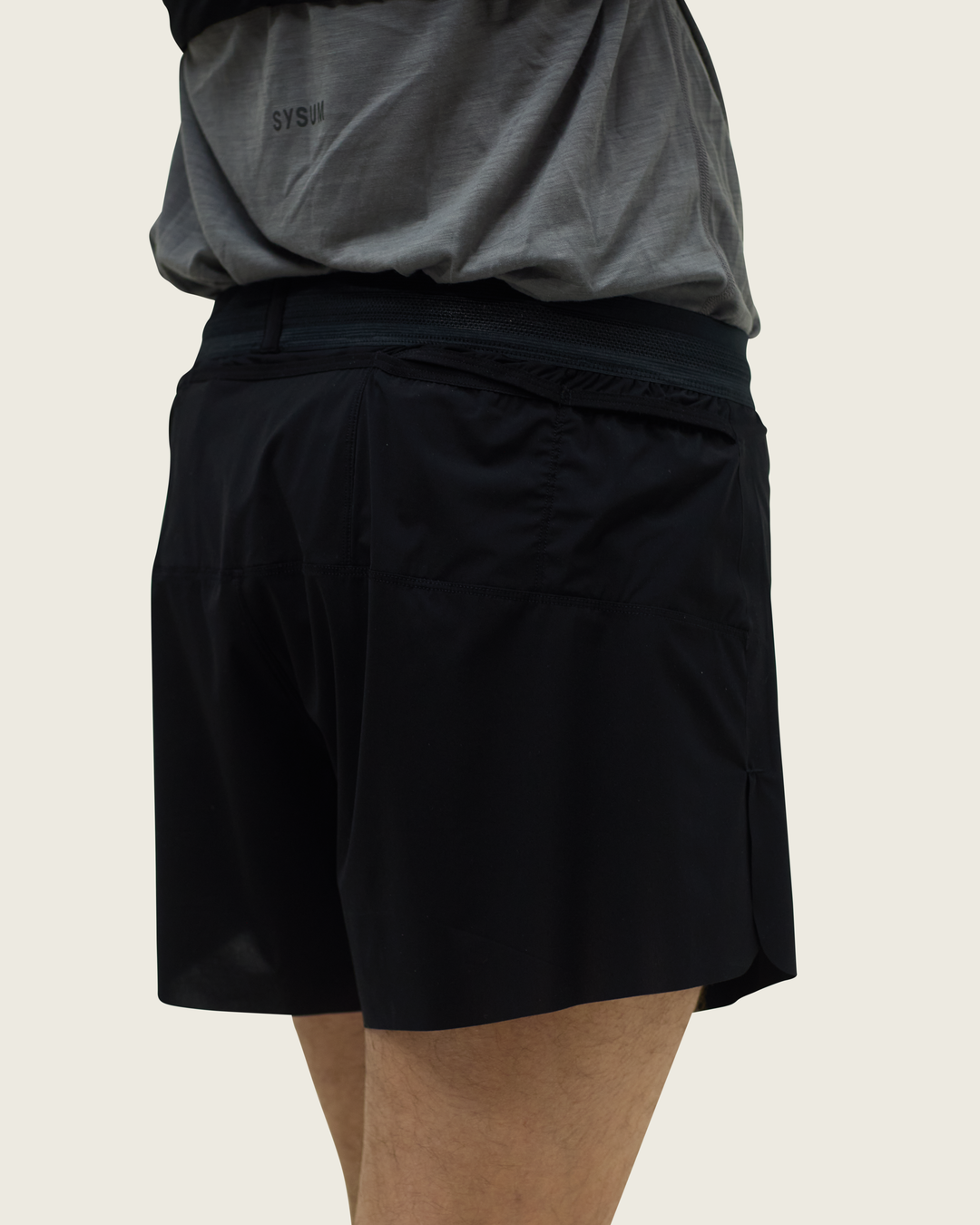 Men’s 4-inch Cordura® trail running shorts in Black from Sysum, ultra-light stretch fabric and pocket system visible, photographed in a neutral studio setting.
