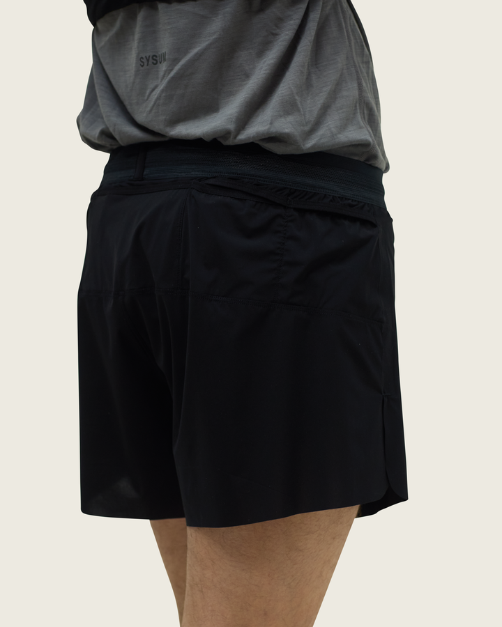 Men’s 4-inch Cordura® trail running shorts in Black from Sysum, ultra-light stretch fabric and pocket system visible, photographed in a neutral studio setting.