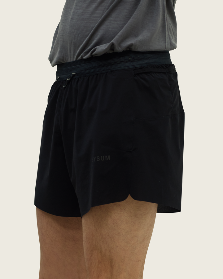 Men’s 4-inch Cordura® trail running shorts in Black from Sysum, ultra-light stretch fabric and pocket system visible, photographed in a neutral studio setting.