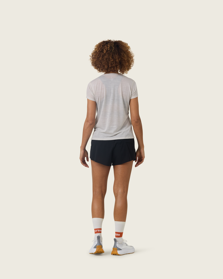 Women’s ultra-light merino short-sleeve running tee in Pebble from Sysum, fine knit texture visible, photographed in a neutral studio setting.