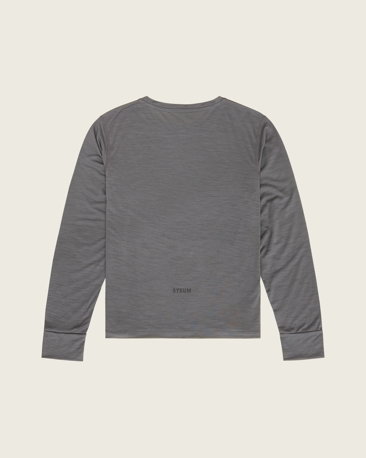 Women’s merino long-sleeve running top in Slate from Sysum, lightweight knit texture visible, photographed in a neutral studio setting.