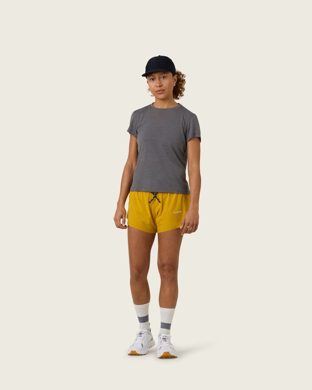 Women’s merino short-sleeve running tee in Slate from Sysum, lightweight knit texture visible, photographed in a neutral studio setting.