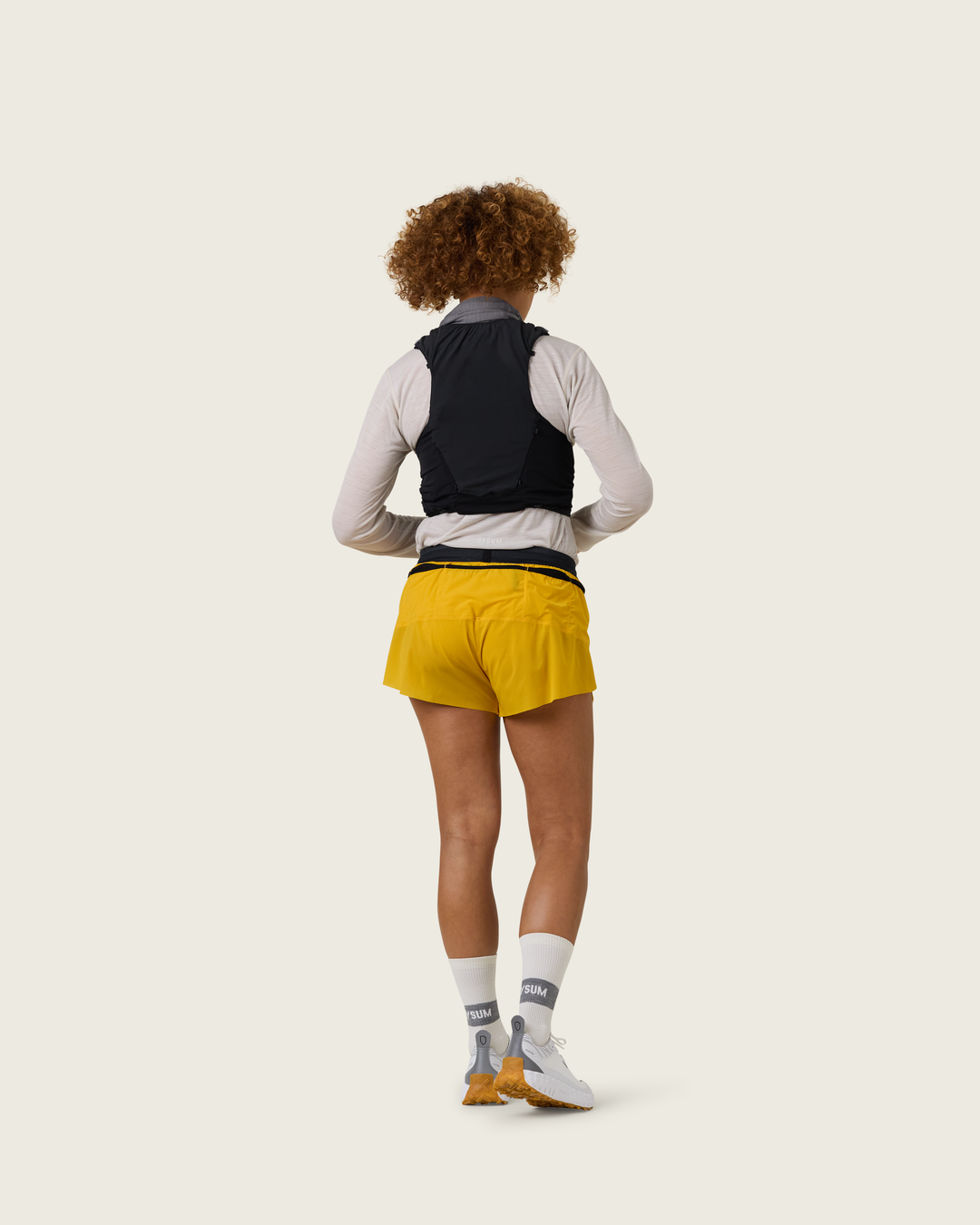 Women’s 3-inch Cordura® trail running shorts in Sap from Sysum, ultra-light stretch fabric and pocket system visible, photographed in a neutral studio setting.