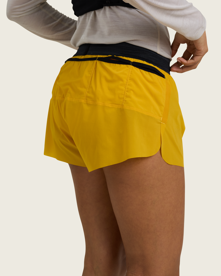 Women’s 3-inch Cordura® trail running shorts in Sap from Sysum, ultra-light stretch fabric and pocket system visible, photographed in a neutral studio setting.