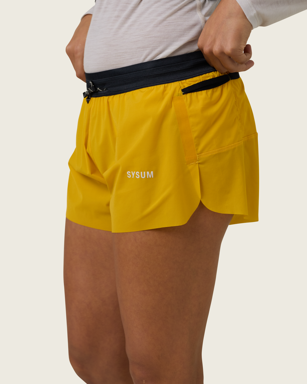 Women’s 3-inch Cordura® trail running shorts in Sap from Sysum, ultra-light stretch fabric and pocket system visible, photographed in a neutral studio setting.