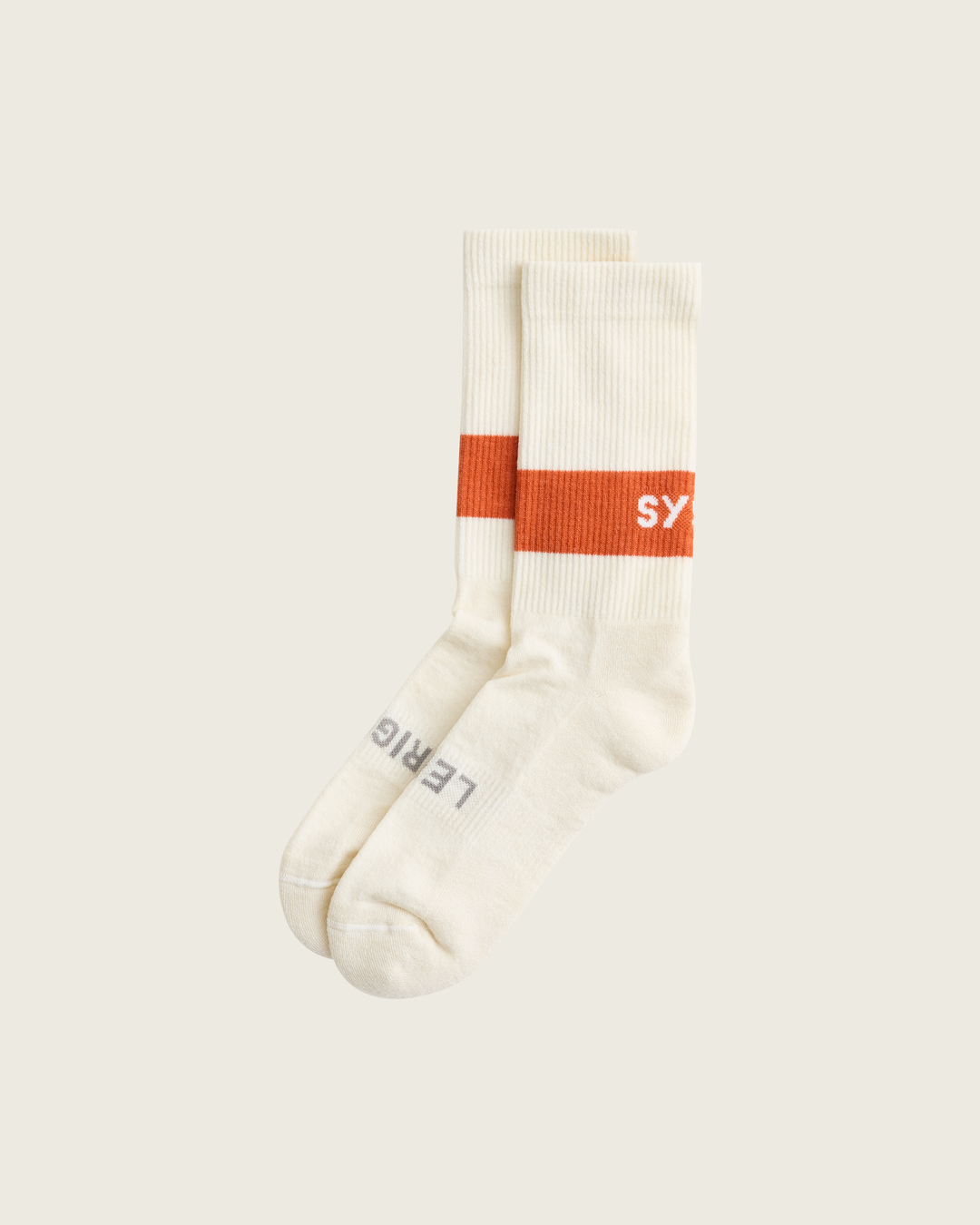 Woollen crew running socks in Clay from Sysum, mid-length design with cushioned zones and textured knit visible, photographed in a neutral studio setting.