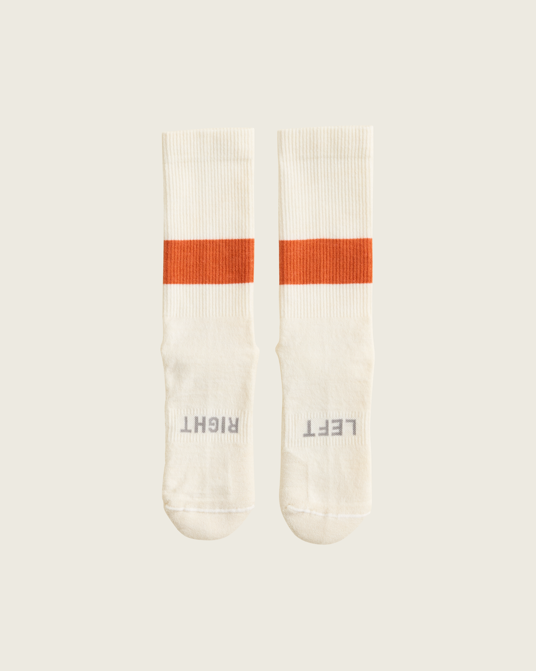 Woollen crew running socks in Clay from Sysum, mid-length design with cushioned zones and textured knit visible, photographed in a neutral studio setting.