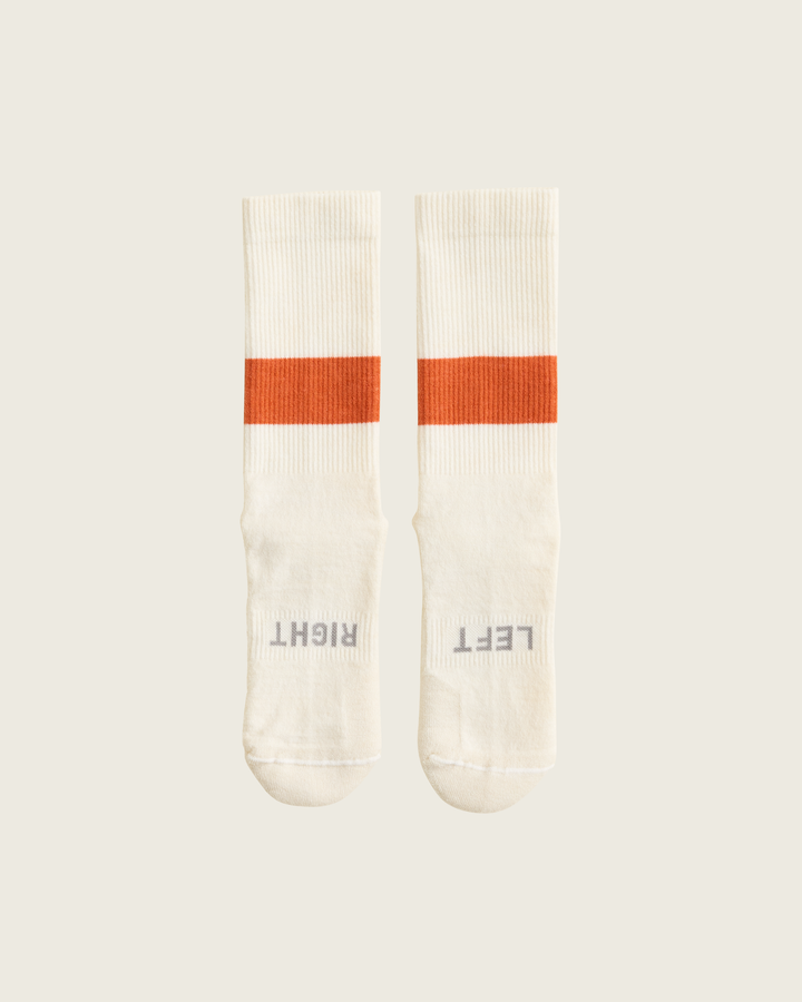 Woollen crew running socks in Clay from Sysum, mid-length design with cushioned zones and textured knit visible, photographed in a neutral studio setting.