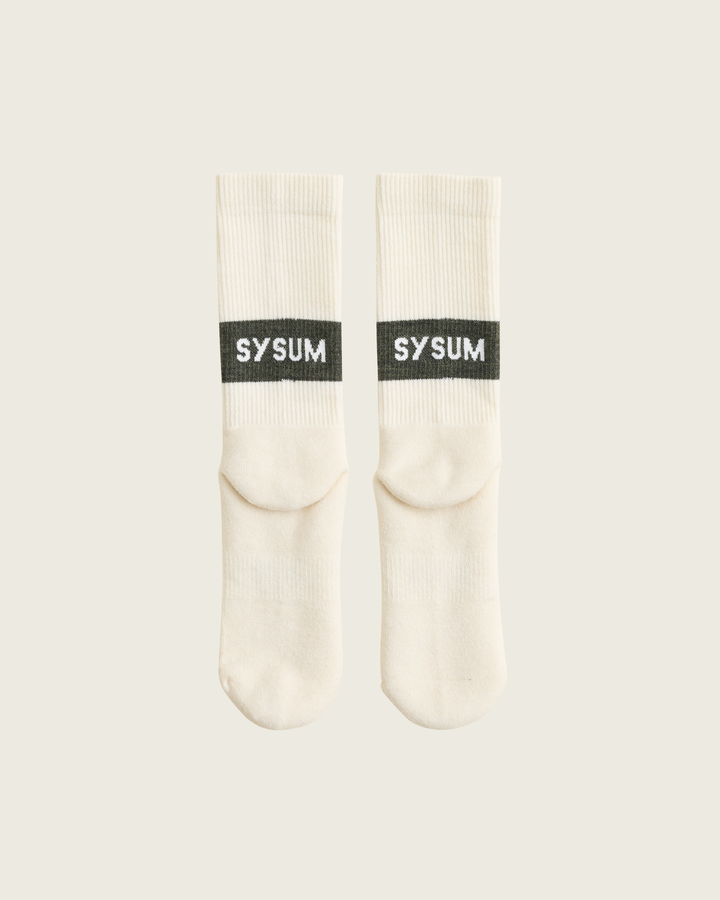 Woollen crew running socks in Moss from Sysum, mid-length design with cushioned zones and textured knit visible, photographed in a neutral studio setting.