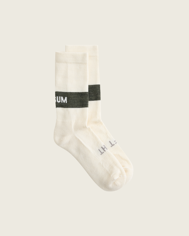 Woollen crew running socks in Moss from Sysum, mid-length design with cushioned zones and textured knit visible, photographed in a neutral studio setting.