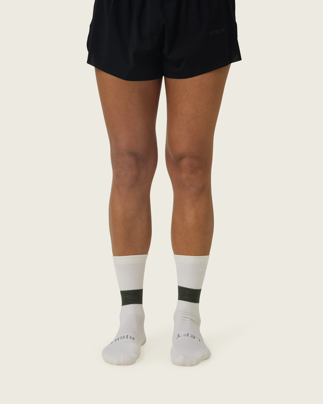 Woollen crew running socks in Moss from Sysum, mid-length design with cushioned zones and textured knit visible, photographed in a neutral studio setting.