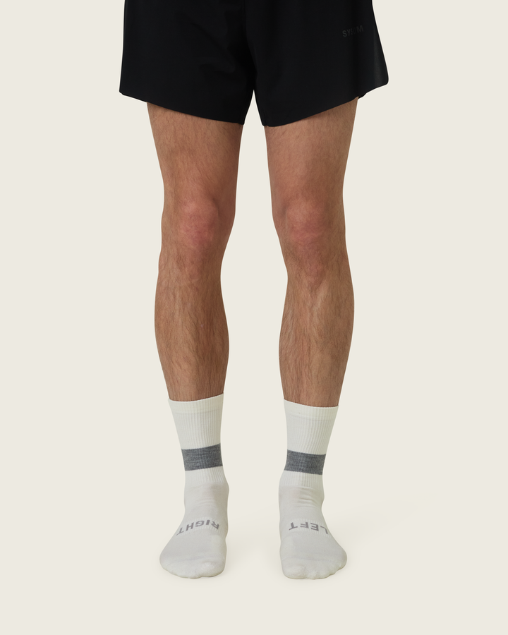 Woollen crew running socks in Slate from Sysum, mid-length design with cushioned zones and textured knit visible, photographed in a neutral studio setting.