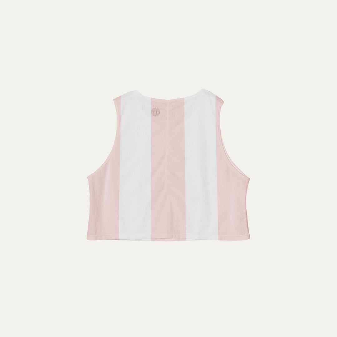 Cropped running singlet from Participation with pink stripe detailing, lightweight polyester construction for warm-weather training and racing, photographed in a neutral studio setting.