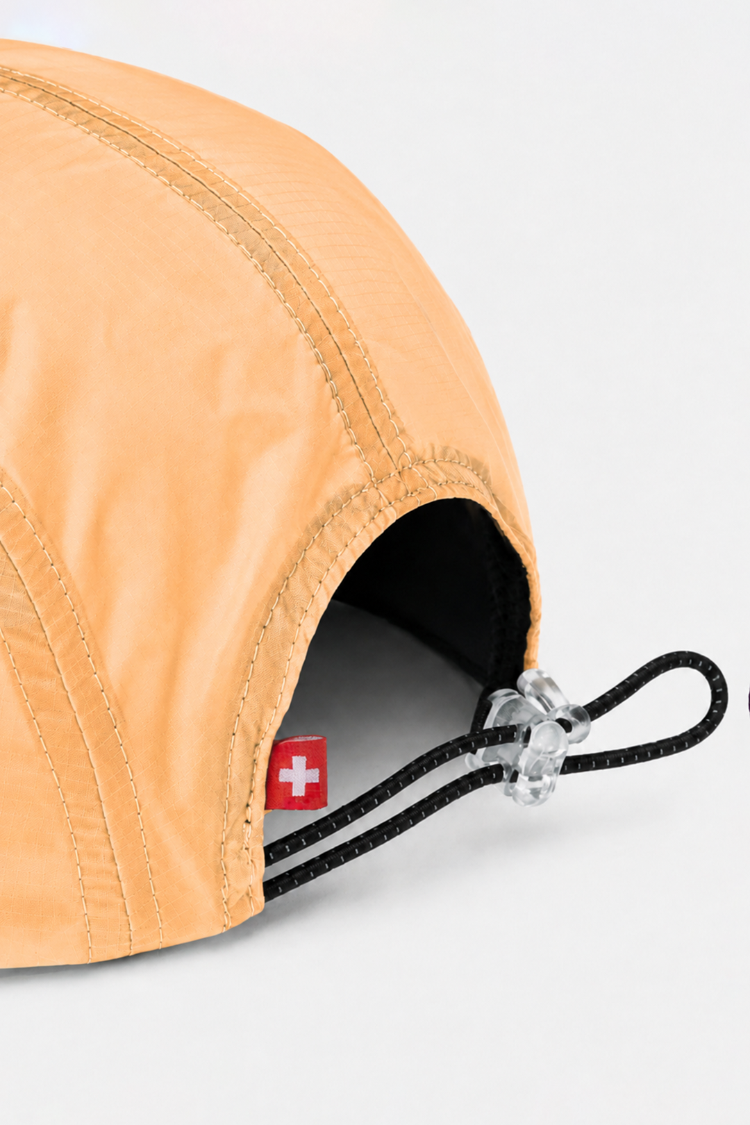 Lievre Running light salmon performance running cap, lightweight technical fabric with adjustable back cord and "Engineered for the Art of Running" text on the side panel.
