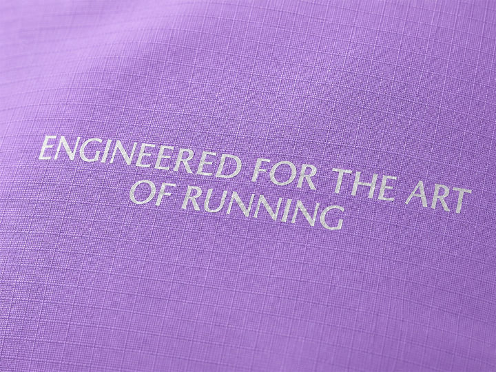 Lievre Running lavender performance running cap, lightweight technical fabric with adjustable back cord and "Engineered for the Art of Running" text on the side panel.