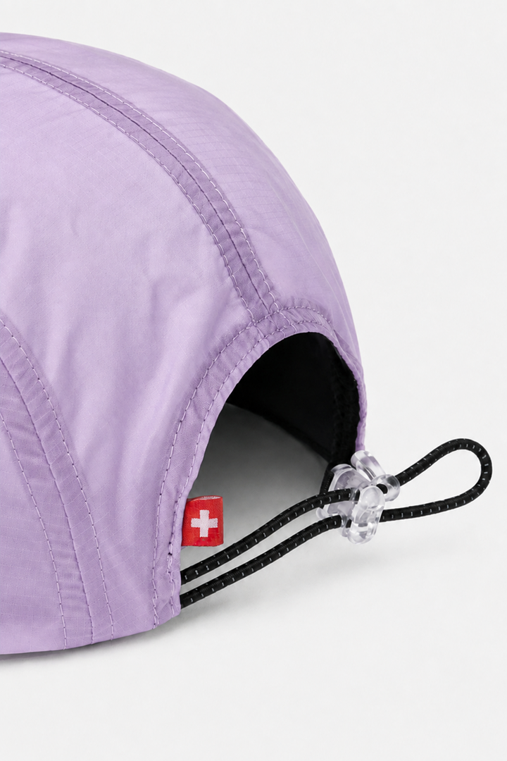 Lievre Running lavender performance running cap, lightweight technical fabric with adjustable back cord and "Engineered for the Art of Running" text on the side panel.