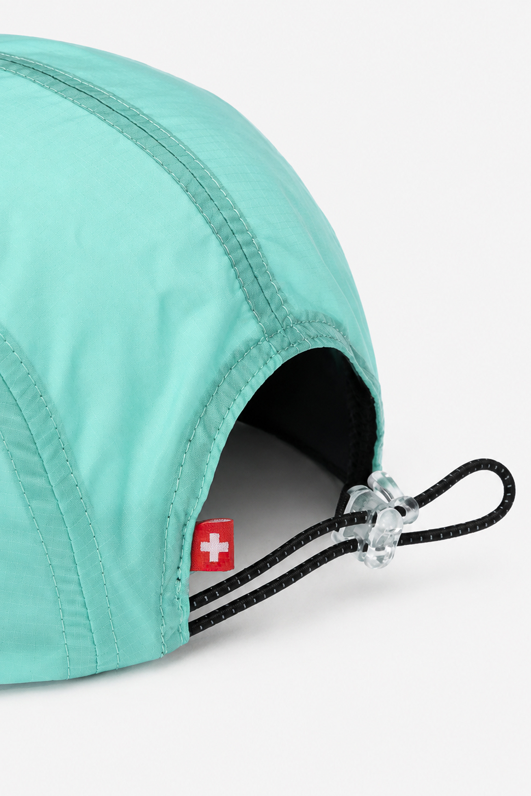 Lievre Running turquoise performance running cap, lightweight technical fabric with adjustable back cord and "Engineered for the Art of Running" text on the side panel.