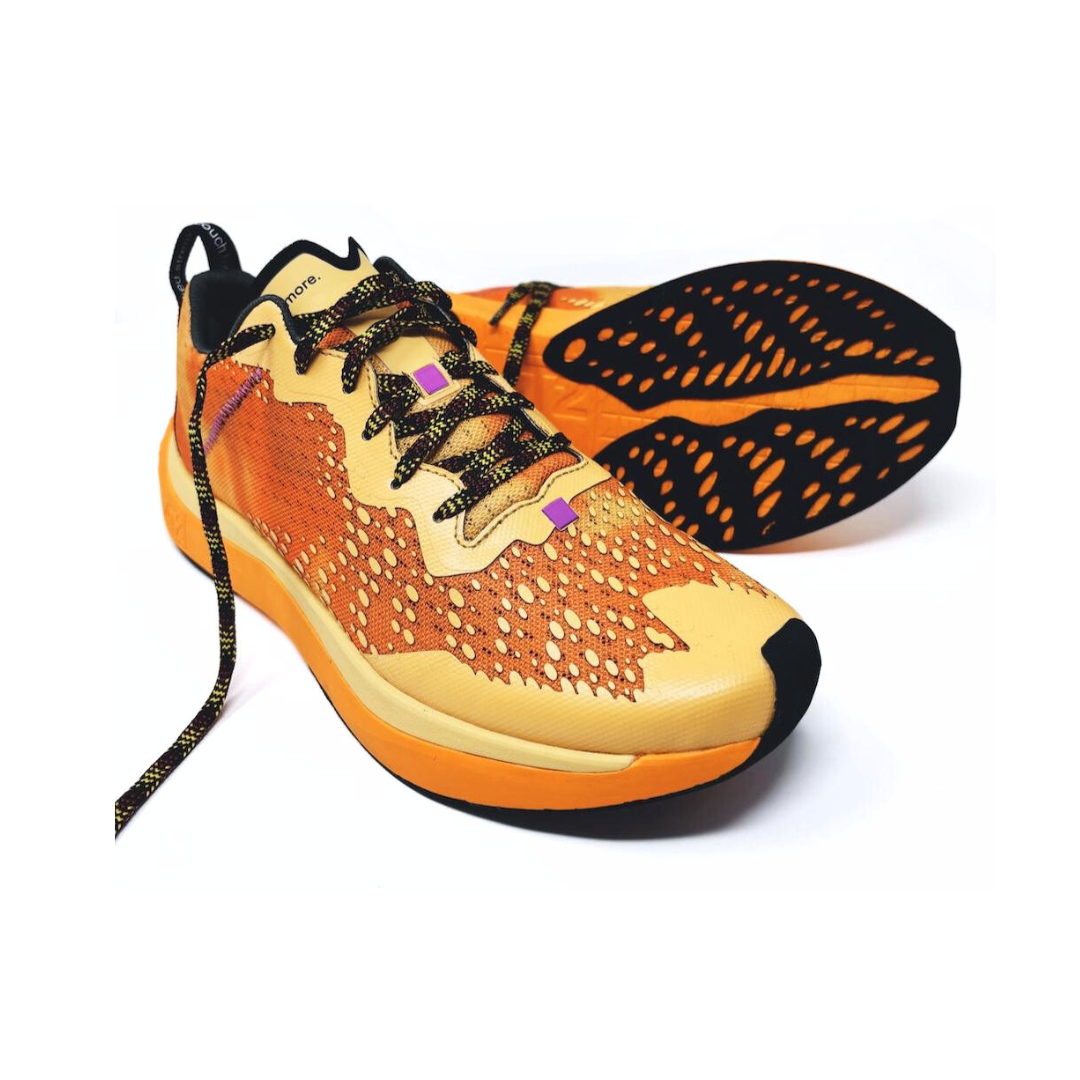 4T2 one more running shoe in orange, featuring a breathable upper and a durable rubber outsole designed for speed and traction.