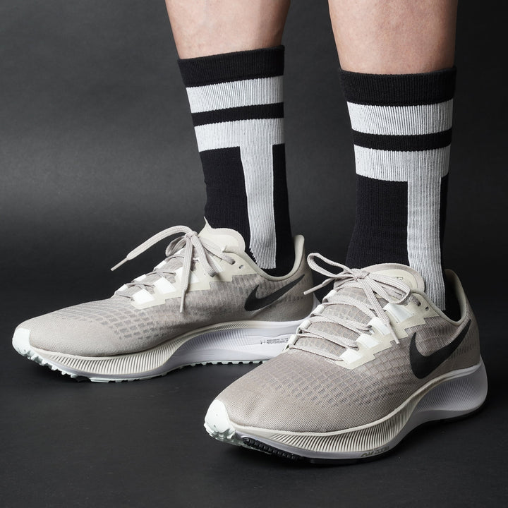 Black crew-length T2 Ultra Socks by Tabisuke Tabizo, featuring foot-mapped knit structure, arch compression, and durable fabric for trail running and fastpacking.