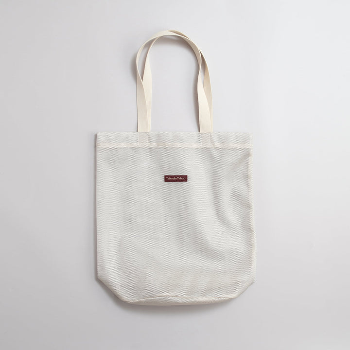 Gray T2 mesh tote bag made from lightweight nylon mesh with minimalist Tabisuke Tabizo branding