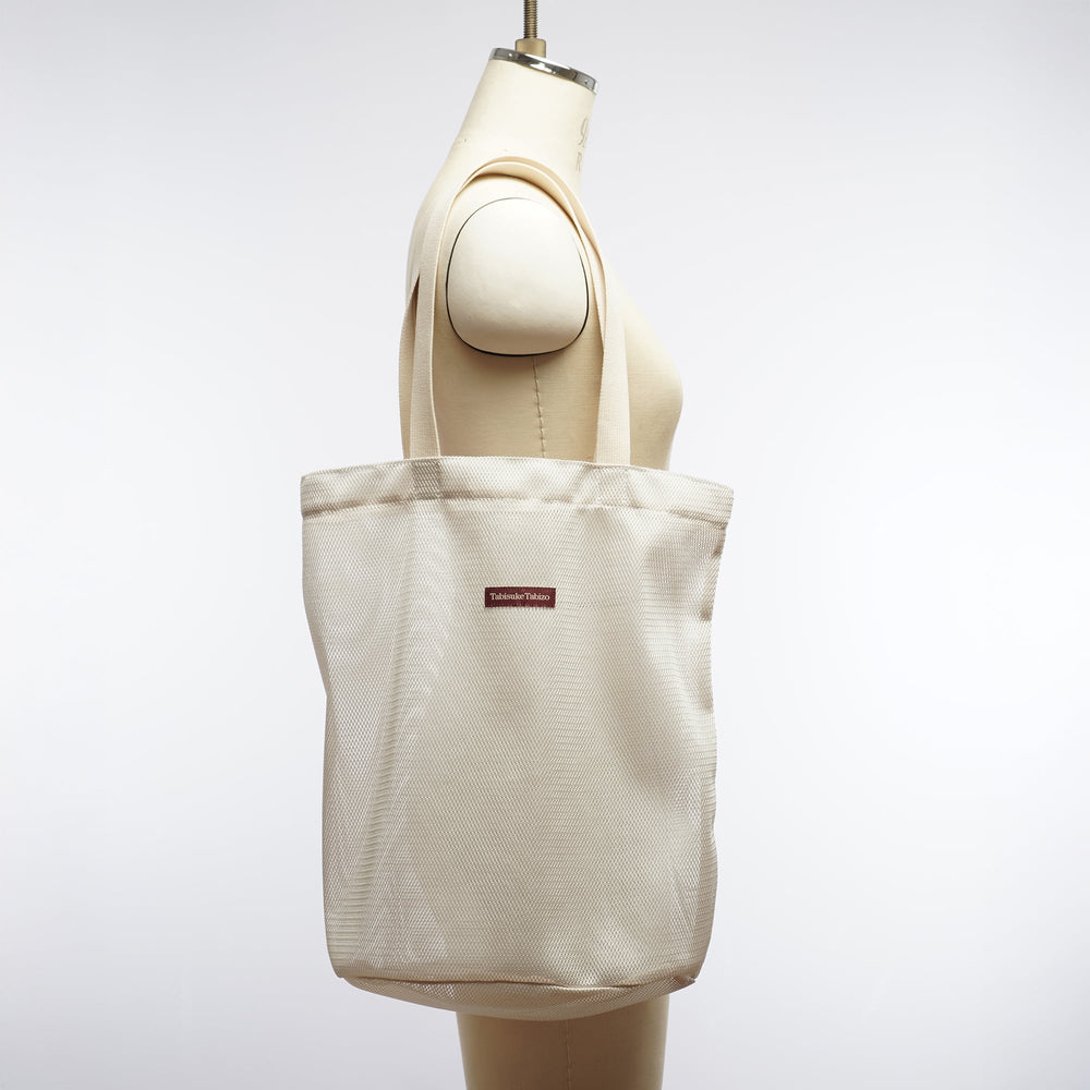 Gray T2 mesh tote bag made from lightweight nylon mesh with minimalist Tabisuke Tabizo branding