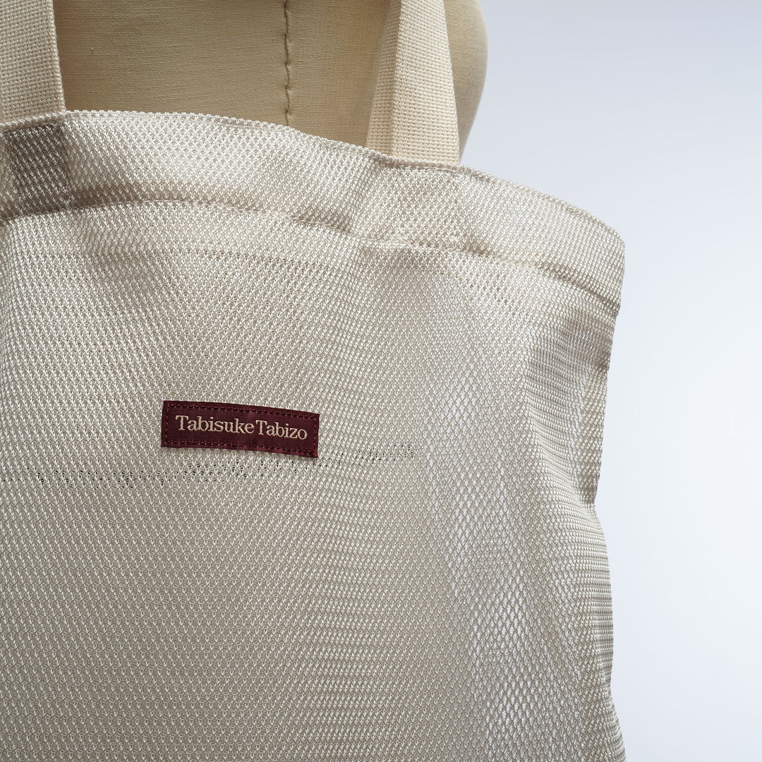 Gray T2 mesh tote bag made from lightweight nylon mesh with minimalist Tabisuke Tabizo branding