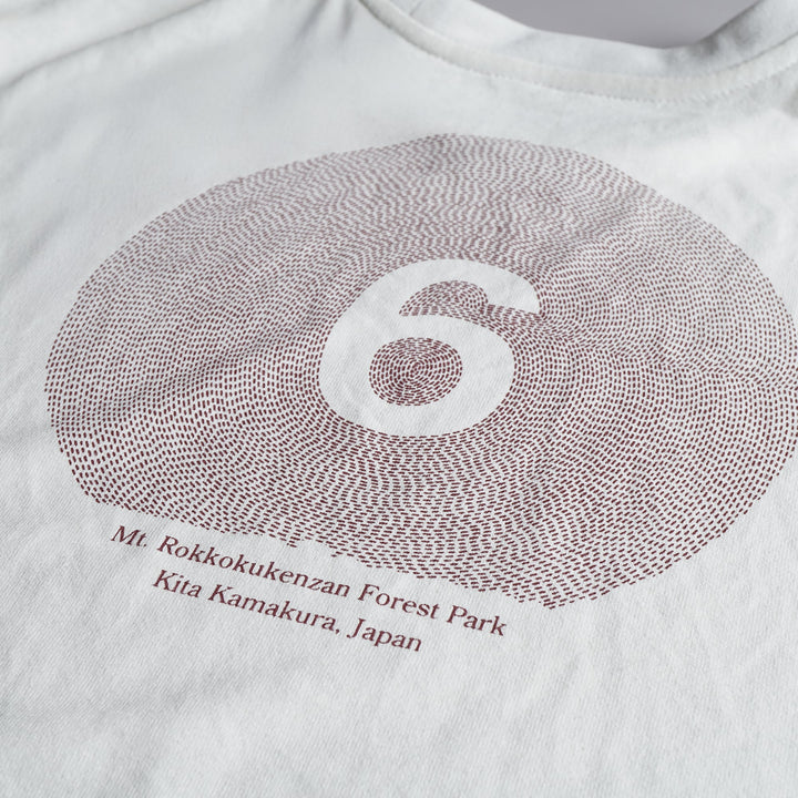 T2 - Trail Tee in white, featuring a relaxed fit and crafted from high-performance Swiftex 2 fabric, displayed on a neutral background.