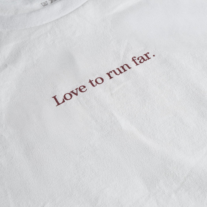 T2 - Trail Tee in white, featuring a relaxed fit and crafted from high-performance Swiftex 2 fabric, displayed on a neutral background.