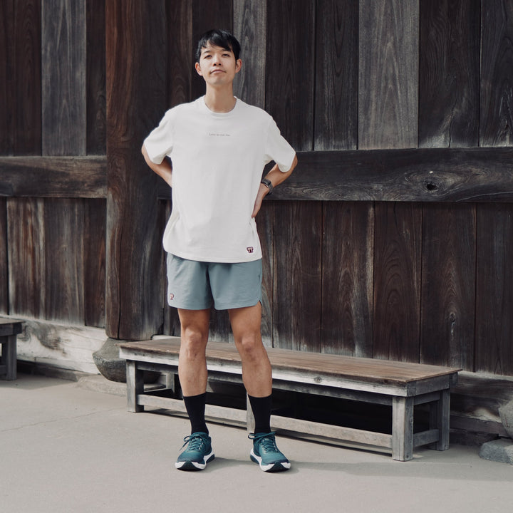 T2 - Trail Tee in white, featuring a relaxed fit and crafted from high-performance Swiftex 2 fabric, displayed on a neutral background.