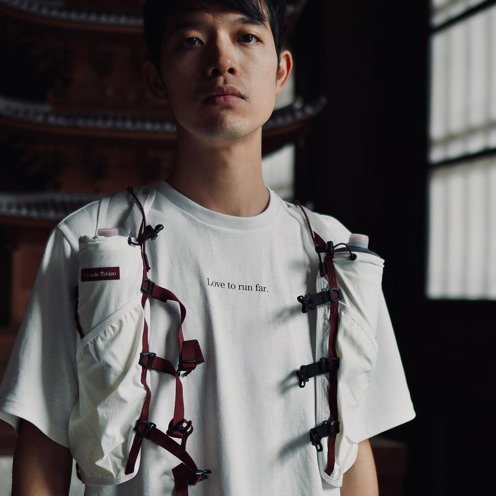 T2 - Trail Tee in white, featuring a relaxed fit and crafted from high-performance Swiftex 2 fabric, displayed on a neutral background.