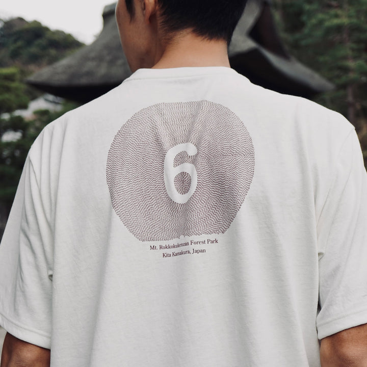 T2 - Trail Tee in white, featuring a relaxed fit and crafted from high-performance Swiftex 2 fabric, displayed on a neutral background.