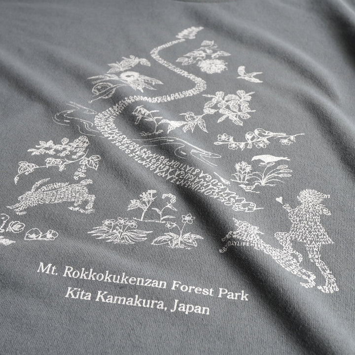 T2 - Trail Tee by Mariko Yamamoto in blue-gray, a relaxed-fit T-shirt made of high-performance fabric, suitable for outdoor activities.