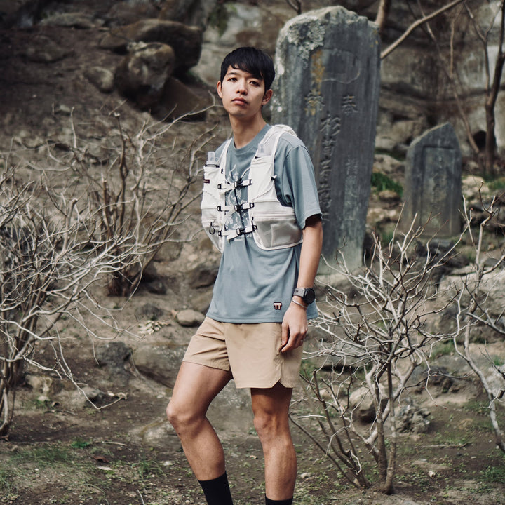 T2 - Trail Tee by Mariko Yamamoto in blue-gray, a relaxed-fit T-shirt made of high-performance fabric, suitable for outdoor activities.