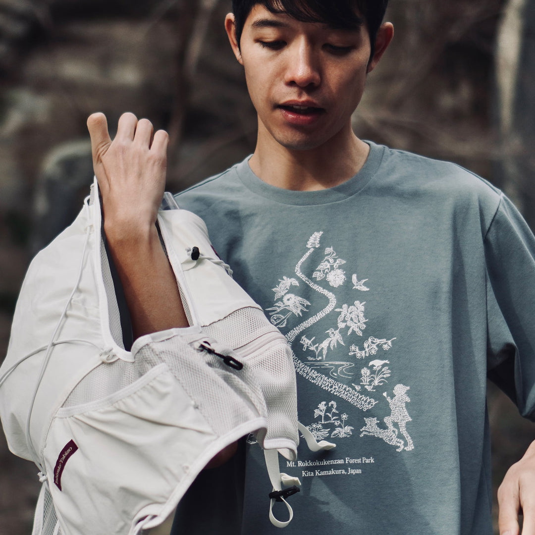 T2 - Trail Tee by Mariko Yamamoto in blue-gray, a relaxed-fit T-shirt made of high-performance fabric, suitable for outdoor activities.