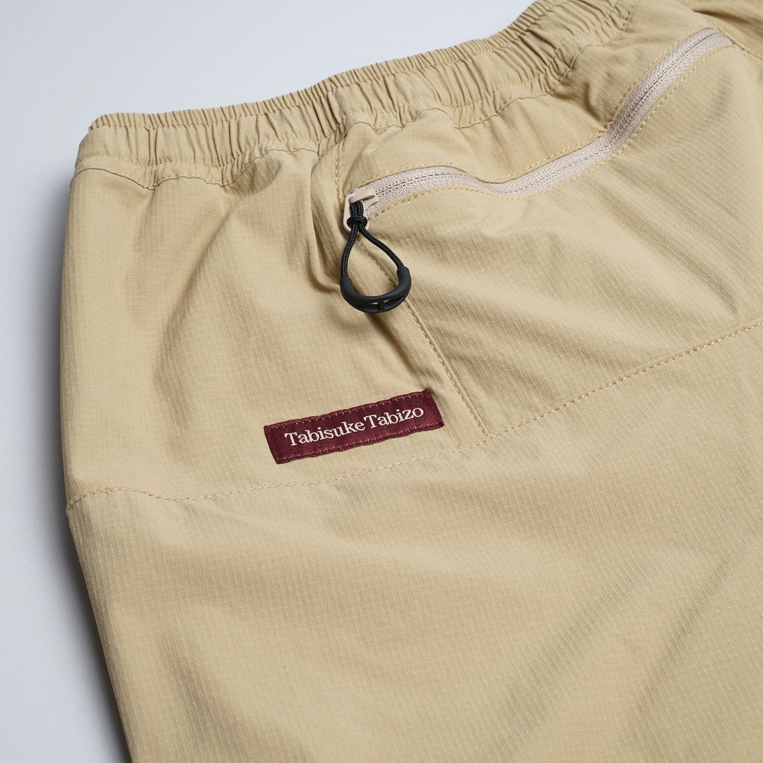 T2 Traverse Pants 2025 fastpacking pants in beige with reinforced crotch and integrated inner shorts