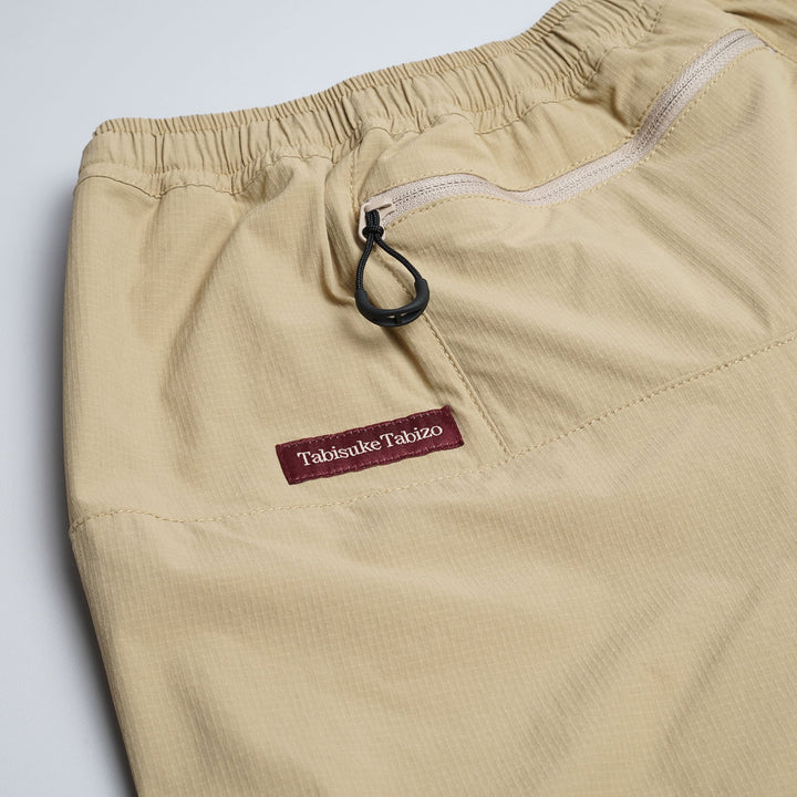 T2 Traverse Pants 2025 fastpacking pants in beige with reinforced crotch and integrated inner shorts